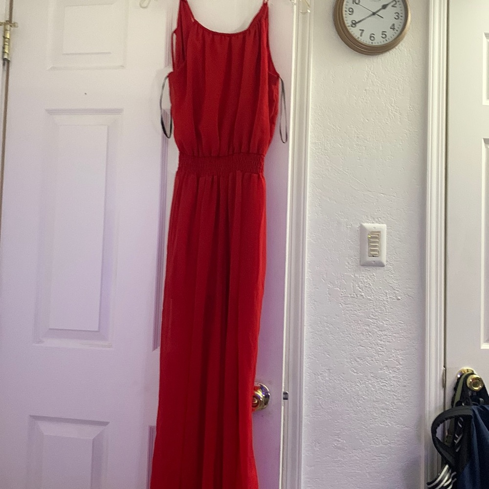 A jumpsuit,spaghetti straps,slits on the bottom